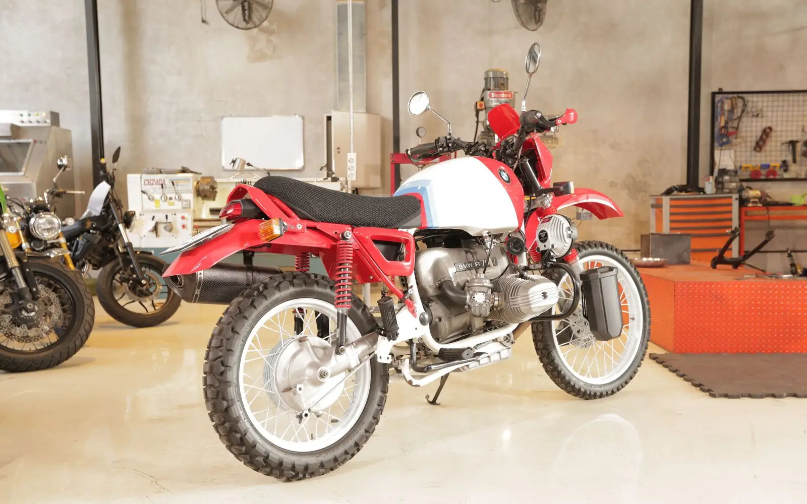 A red and white BMW R80 G/S build, three-quarter front