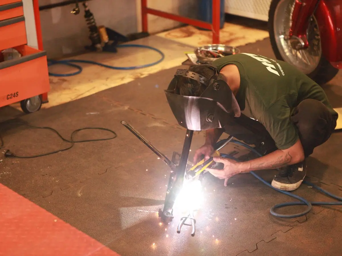 Welding on the workshop floor, sparks flying