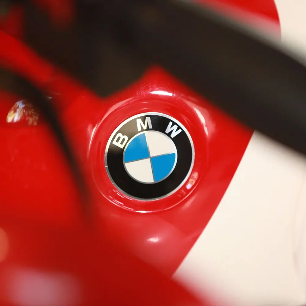 The BMW roundel on a gloss red and white tank