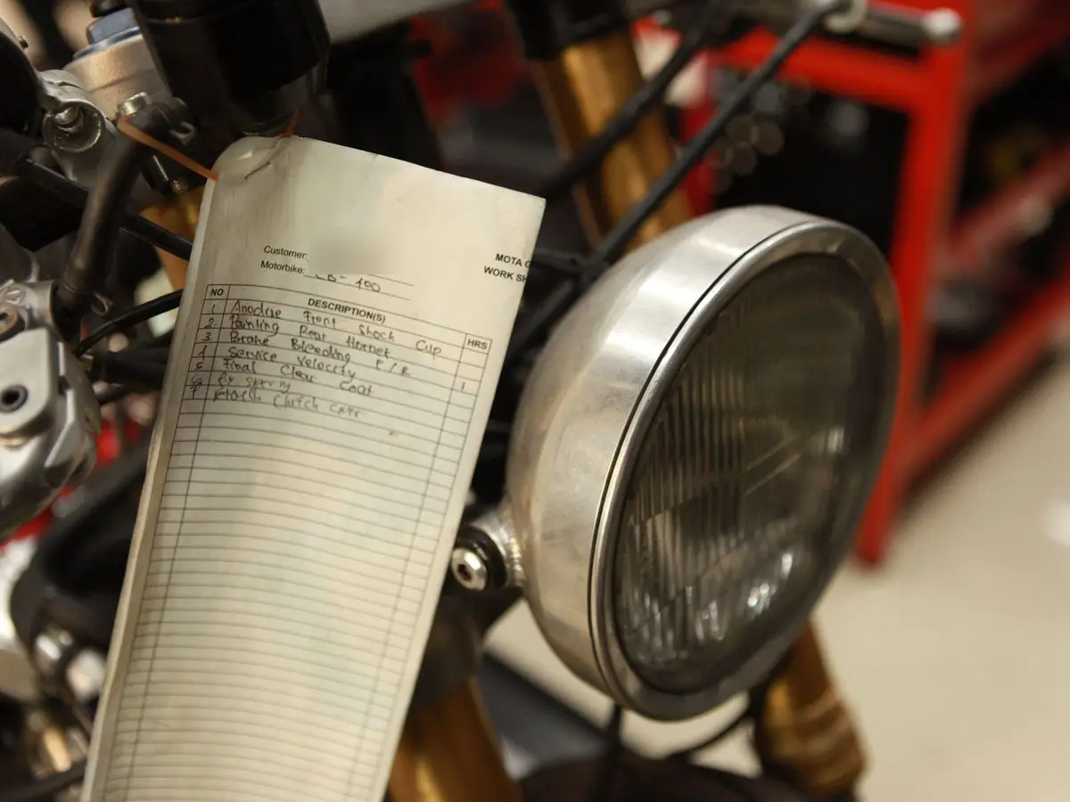 A MOTA work sheet hung beside a headlight
