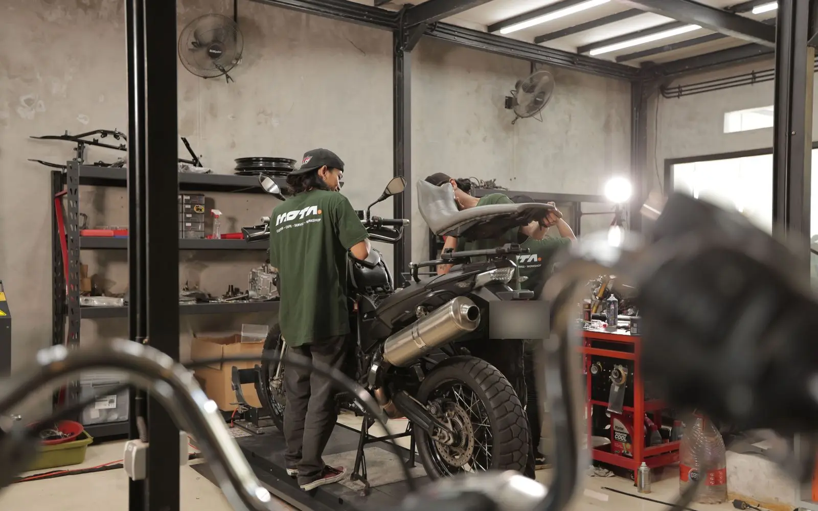 The workshop floor, mechanics and bikes in progress