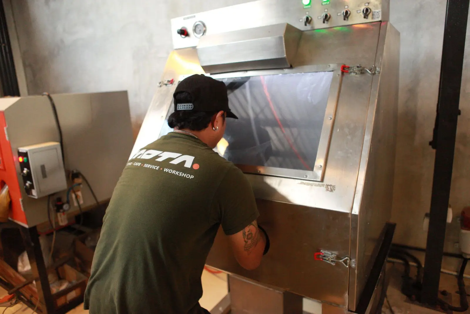 An operator at the stainless vapor blasting cabinet